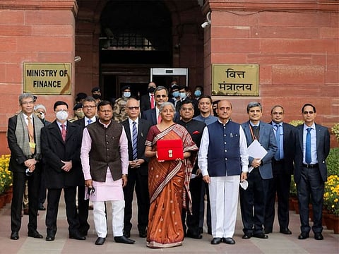India's Finance Minister Nirmala Sitharaman holds up a folder with the Government of India’s logo as she leaves her office to present the federal budget in the parliament in New Delhi, India, February 1, 2022.