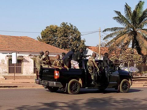 Armed soldiers move on the main artery of the capital after heavy gunfire around the presidential palace in Bissau, Guinea Bissau February 1, 2022.
