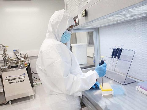 A production scientist works with samples at the Afrigen Biologics' site in Cape Town.