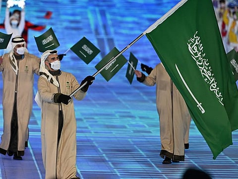 Saudi Arabia's flag bearer Fayik Abdi leads the delegation during the opening ceremony of the Beijing 2022 Winter Olympic Games, at the National Stadium, known as the Bird's Nest, in Beijing.