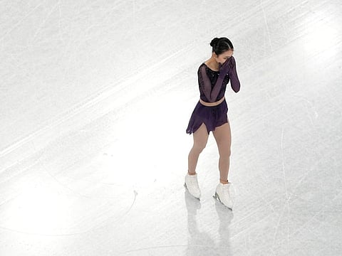Zhu Yi, of China, reacts as she heads off the ice after completing her routine in the women's short program team figure skating competition at the 2022 Winter Olympics.
