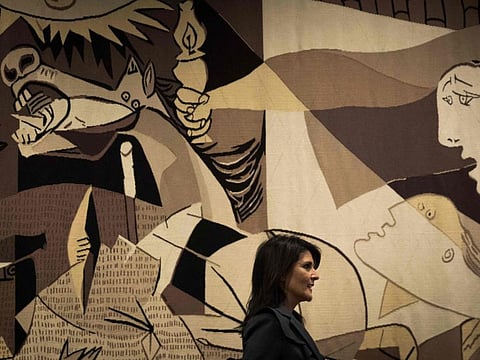 In this file photo taken on January 2, 2018, US ambassador to the United Nations Nikki Haley walks past a replica of 'Guernica' by Pablo Picasso as she arrives for a press availability at the United Nations headquarters in New York City. - One year after its sudden and disconcerting disappearance from a wall at the United Nations, a vast tapestry representing Picasso's iconic "Guernica" has been returned by owners the Rockefeller family to its prominent place at the global body.