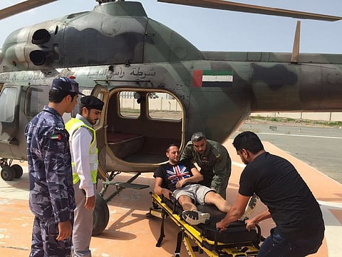 A man being assisted by the RAK Police air wing.