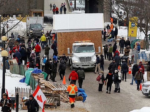 A shack that was being used as a soup kitchen is hauled away as truckers and their supporters continue to protest against the COVID-19 vaccine mandates in Ottawa, Ontario, Canada, February 6, 2022.
