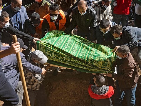 Moroccans burry five-year-old Rayan Oram in the village of Ighrane in Morocco's rural northern province of Chefchaouen, on February 7, 2022.