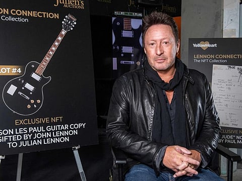 In this file photo taken on January 25, 2022, artist/musician Julian Lennon poses in front of the NFT (non-fungible token) part of "Lennon Connection: The NFT Collection" auction featuring cherished Beatles and John Lennon memorabilia from his private collection, at Julien's Auctions, in Beverly Hills, California.