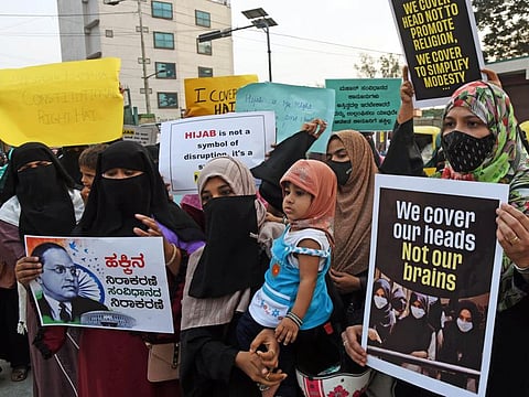 Muslim women hold placards in favour of Hijab in Bengaluru on Monday.