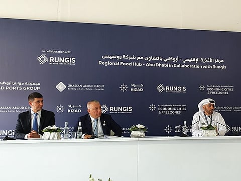 Abdullah Al Hameli (centre) with Ghassan Aboud (second from left) and Graham Sanders during the announcement for the new wholesale food market in Abu Dhabi today.