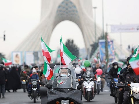 Iranians ride on motorcycles as they participate in the celebration of the 43rd anniversary of the Islamic Revolution in Tehran, on February 11, 2022.