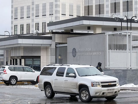 A diplomatic car drives out of the territory of the U.S. embassy in Kyiv, Ukraine February 12, 2022.