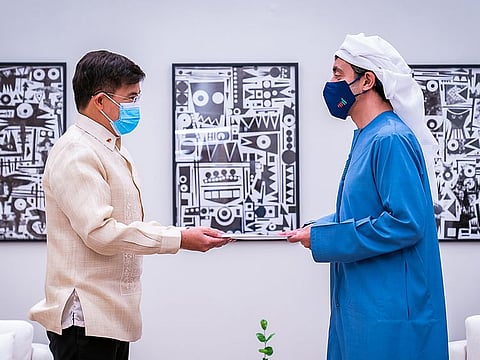 Sheikh Abdullah bin Zayed Al Nahyan (R) receives message from Philippines President delivered by his Special Envoy Robert Borje (L) at Expo 2020 Dubai