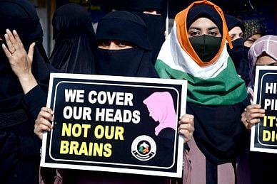 A woman wears India's tri-colour (national flag) hijab during a protest against the hijab ban imposed in the few colleges in Karnataka, outside Mira Road Railway Station, in Mumbai on Friday.