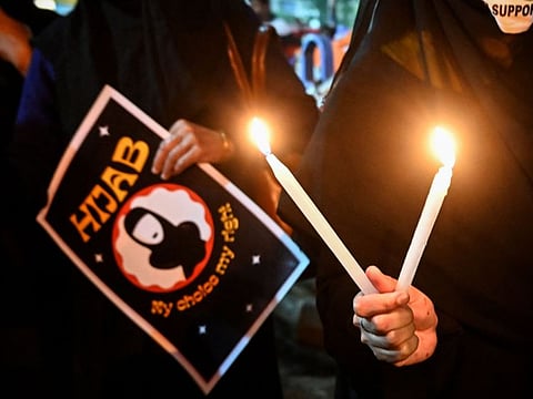 Women hold placards as they take part in a demonstration in Kolkata on February 11, 2022.
