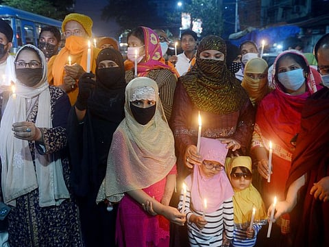 Women hold a candle light rally against the hijab ban imposed in the few colleges in Karnataka, at Moulali Crossing, in Kolkata on Sunday.