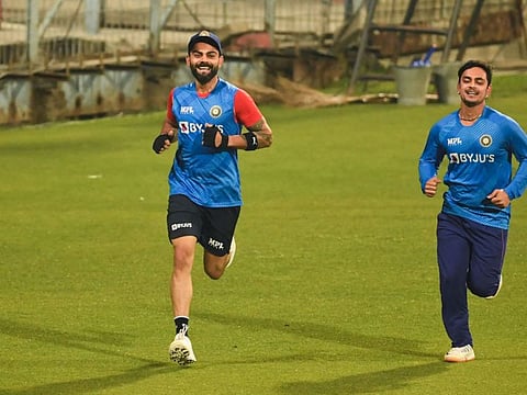 Ishan Kishan (right) runs along with India's star batter Virat Kohli during a training session in Kolkata on Monday. The left-hander has earned more than Kohli in the recently concluded auction. While Kohli was retained for Rupees 150 million, Kishan has been bought back by Mumbai for Rupees 152.5 million.