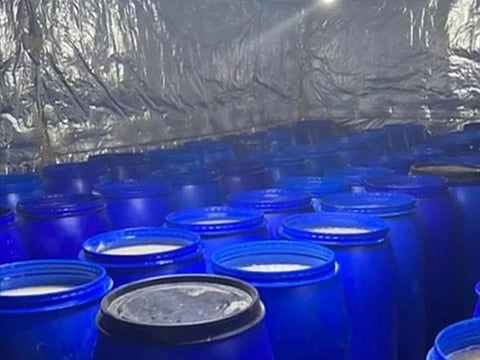 Barrels of illicit liquor seized during the raid.
