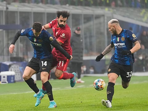 Liverpool's Mohamed Salah (centre) is challenged by Inter Milan's Ivan Perisic (left) and Federico Dimarco during the Champions League, round of 16, first leg match at the San Siro stadium in Milan, Italy.