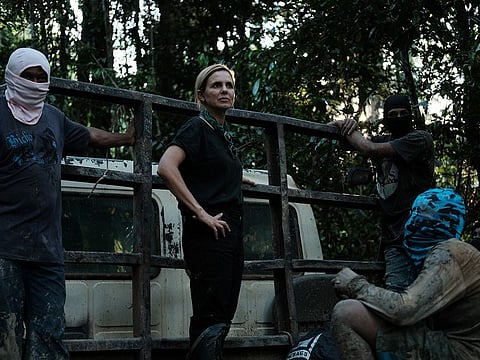 Mariana van Zeller on a truck with loggers.