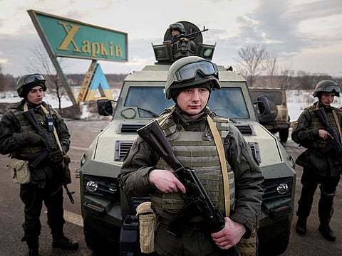 Ukrainian National guard soldiers guard a mobile checkpoint together with the Ukrainian Security Service agents and police officers during a joint operation in Kharkiv, Ukraine, Thursday, Feb. 17, 2022.