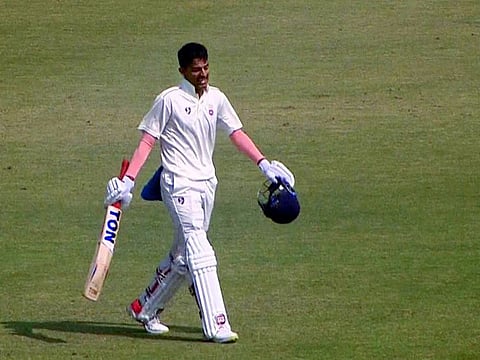 Delhi's Yash Dhull celebrates his century on his debut during the Ranji Trophy match against Tamil Nadu at Barsapara Cricket Stadium in Guwahati on Thursday.