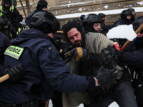Canadian Police officers move protestors towards parliament hill, as they work to restore normality to the capital while trucks and demonstrators continue to occupy the downtown core for more than three weeks.
