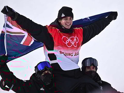 Gold medalist New Zealand's Nico Porteous is carried by his team during a venue ceremony after the freestyle skiing men's freeski halfpipe final run during the Beijing 2022 Winter Olympic Games at the Genting Snow Park H & S Stadium in Zhangjiakou.