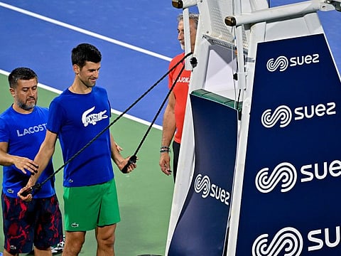 Novak Djokovic doing some strength training exercises during a practice session ahead of the Dubai Duty Free Tennis Championships at the Dubai Stadium on Sunday.