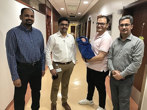 The newborn patient with his father and the Zulekha Hospital Dubai team.