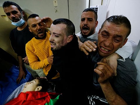 Relatives react next to the body of Palestinian boy, Mohammed Shehadeh, who was killed by Israeli troops in Bethlehem, in the Israeli-occupied West Bank February 23, 2022.