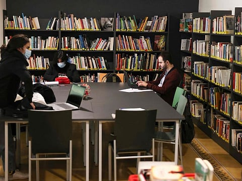 People work at one of the Lebanese capital Beirut's public libraries, in the Bachoura neighbourhood, on February 11, 2022.