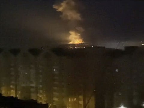 A flame is seen from an area near the Dnieper river in Kyiv, Ukraine, on Thursday.