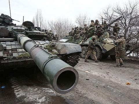 Ukrainian servicemen get ready to repel an attack in Ukraine's Lugansk region on February 24, 2022.