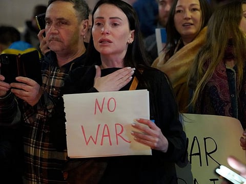 People protest the Russian invasion of Ukraine at a demonstration in the Studio City neighborhood of Los Angeles, Thursday, Feb. 24, 2022.