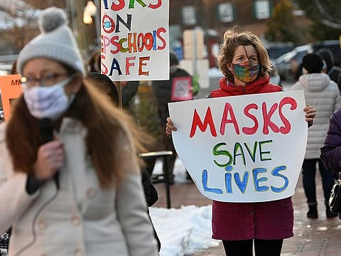 People gather at the Loudoun County, Va., government center last month to show support for a continuation of the school district's mask mandate.