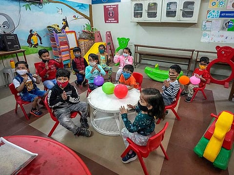 Children wearing face masks as a precaution against the coronavirus attend a pre-school in Ahmedabad, India, Thursday, Feb. 17, 2022.