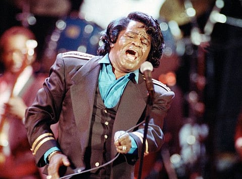 Gospel-soul singer James Brown sings "Living in America" during his three-hour concert at the Wiltern Theater in Los Angeles, on June 10, 1991.