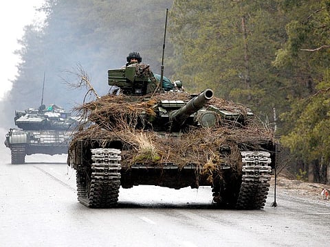 Ukrainian tanks move on a road before an attack in Lugansk region on February 26, 2022.