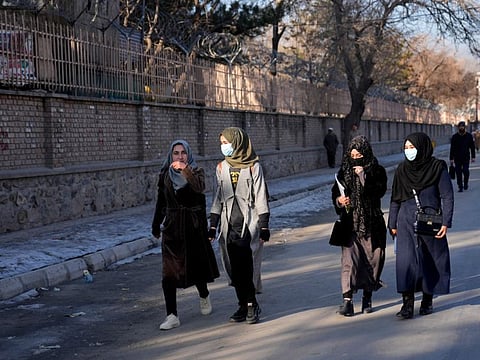 Afghan students walk toward their university in Kabul on February 26, 2022. Kabul University, among Afghanistan’s oldest and most revered institutions of higher education, reopened Saturday six months after the Taliban retook the country.