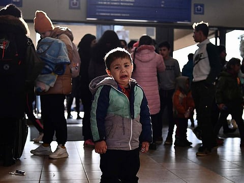 A refugee boy who fled conflict from neighboring Ukraine cries at the railway station after arriving to Zahony, Hungary