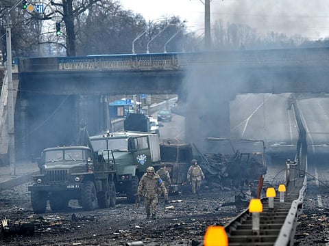 Ukrainian service members are seen at the site of a fighting with Russian raiding group in the Ukrainian capital of Kyiv in the morning of February 26, 2022, according to Ukrainian service personnel at the scene.