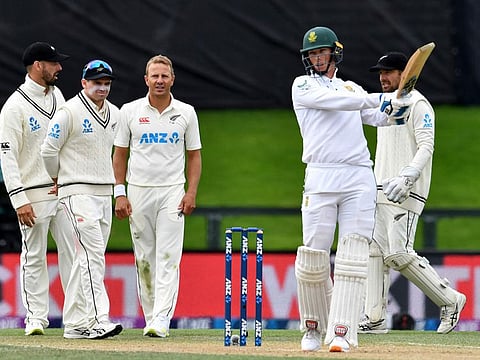 New Zealand's Daryl Mitchell (left), Tom Latham (second left), Neil Wagner (C) and Tom Blundell (right) wait for the third umpire's decision of a caught behind appeal against South Africa's Rassie van der Dussen on day three of the second cricket Test at Hagley Oval in Christchurch.