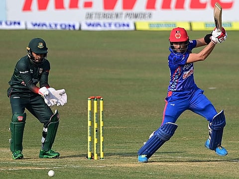 Afghanistan's Rahmanullah Gurbaz (right) plays a backfoot cover drive during his century against Bangladesh in the third One Day International at the Zahur Ahmed Chowdhury Stadium in Chittagong on Monday.