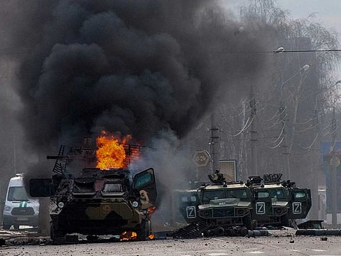 An armoured personnel carrier burns amid damaged light utility vehicles in Kharkiv, Ukraine, on Sunday