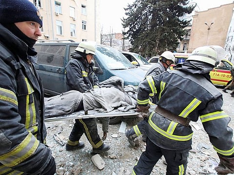 Rescuers carry the body of a victim on a stretcher outside the regional administration building, which city officials said was hit by a missile attack, in central Kharkiv, Ukraine, March 1, 2022.