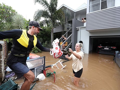 Volunteer and Kingscliff resident Dave Prince hands supplies to flooded resident Kirri Henry in Fingal, New South Wales, Australia, on March 1, 2022.