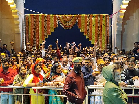 Devotees in large numbers arrive to offer prayers on the occasion of Maha Shivaratri, at Shri Kashi Vishwanath Temple, in Varanasi on Tuesday.