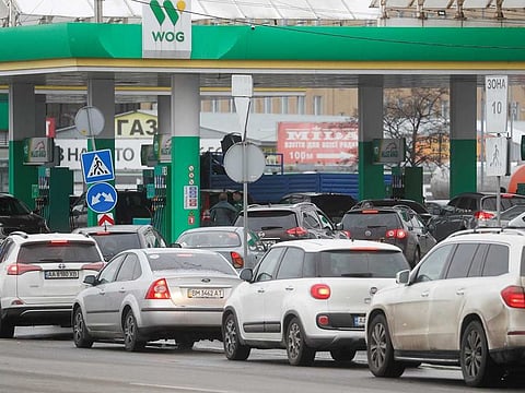Drivers line up next to a petrol station to refill their car tanks, as Russia's war in Ukraine continues, in Kyiv, Ukraine March 1, 2022.