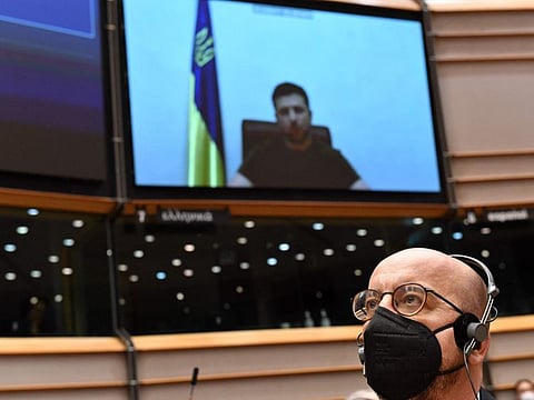 President of the European Council Charles Michel listens to Ukrainian President Volodymyr Zelensky (on screen) as he gives a live video address during a special plenary session of the European Parliament focused on the Russian invasion of Ukraine at the EU headquarters in Brussels, on March 1, 2022.