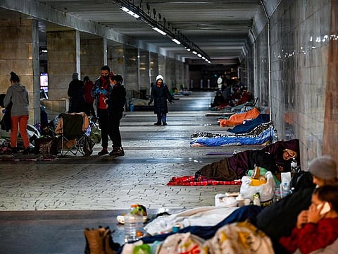 Civilians take shelter at an underground metro station in Kyiv on March 2, 2022. On the seventh day of fighting in Ukraine Russia claims control on March 2, 2022 of the southern port city of Kherson, street battles rage in Ukraine's second-biggest city Kharkiv, and Kyiv braces for a feared Russian assault.