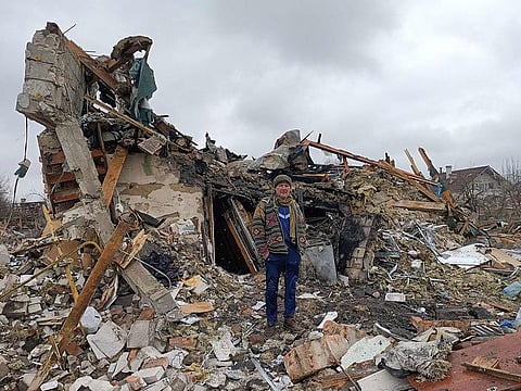 A Ukrainian man stands in the rubble in Zhytomyr, following a Russian bombing.